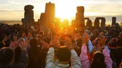Revellers gather at the World Heritage site at Stonehenge in Wiltshire in 2010 to watch the sunrise during the summer solstice, marking the longest day of the year.