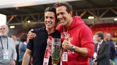 Wrexham co-owners McElhenney (left) and Ryan Reynolds (right) hold a League One promotion trophy