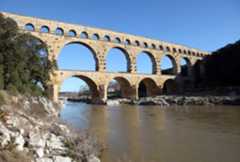 This is the Roman aqueduct of Pont du Gard, which crosses the Gard River, located in France. It is a UNESCO World Heritage Site.