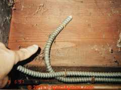 Abandoned armored cable wiring - improper and unsafe (C) Daniel Friedman InspectApedia.com