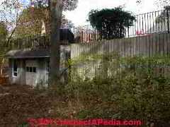 High retaining wall with guardrail © D Friedman at InspectApedia.com