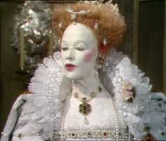 Elizabeth R in costume and make up looking away from the camera