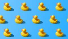 Pixilated ducks Rows of yellow rubber ducks, some blurred with blocky pixels.