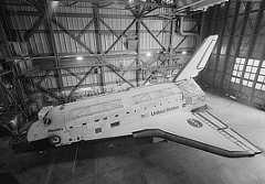 Photo shows a port side view of a space shuttle from an elevated platform.