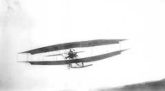Photo shows a biplane in the air.