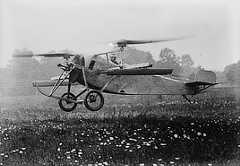 Photo shows a helicopter rising up from a field.