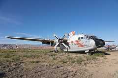 Color photo shows a side view of an airplane painted gray and white with a lightening bolt symbol.