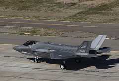 Color photo shows a U.S. Air Force fighter plane on a runway.