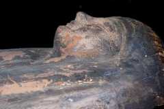 Human head carved in coffin's lid.