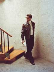 Image may contain Glen Powell Clothing Coat Jacket Blazer Adult Person Standing Accessories Glasses and Pants