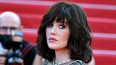 A woman with brown hair being photographed on the red carpet
