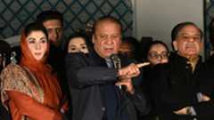 Pakistan's former prime minister stands addresses supporters pointing his finger