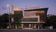 Photo of an office building with a Huione Pay sign on top.