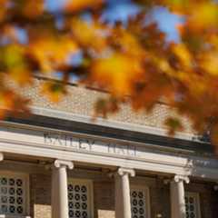 The exterior Cornell University's Bailey Hall with autumn foliage in the foreground.