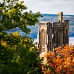 The Cornell University War Memorial in afternoon light, with Cayuga Lake beyond, all framed by autumn foliage.