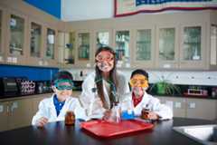 Three kids in the chemistry lab.