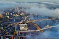aerial of downtown Portland with clouds floating over buildings and bridges