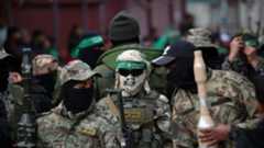 Palestinian fighters from the Ezzedine al-Qassam Brigades, the armed wing of Hamas, take part in the funeral procession of Marwan Issa, a top Hamas commander killed in March 2024, in the war-devastate