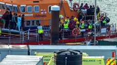 Migrants picked up at sea while attempting to cross the English Channel, are brought by a UK Royal National Lifeboat Institution (RNLI) lifeboat into the Marina in Dover, southeast England.