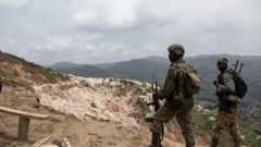 M23 soldiers stand at the mining pits in Rubaya on 5 March, 2025. Ravaged by conflict for 30 years, eastern DRC is believed to hold between 60% and 80% of the world's reserves of coltan, an essential mineral for manufacturing electronic equipment.
