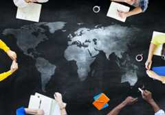 Map of the global surrounded by various people's hands holding or writing in notebooks