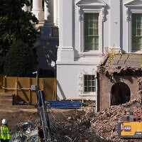 Construction workers atop the US Treasury, bottom left, watch as work continues on a largely demolished part of the East Wing of the White House, October 23, 2025, in Washington, before construction of a new ballroom. (AP Photo/Jacquelyn Martin) Construction workers atop the US Treasury, bottom left, watch as work continues on a largely demolished part of the East Wing of the White House, October 23, 2025, in Washington, before construction of a new ballroom. (AP Photo/Jacquelyn Martin)