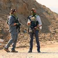Illustrative: Armed men stand guard at a checkpoint manned by US and Egyptian security at the Netzarim corridor as displaced Palestinians make their way from the south to the northern parts of the Gaza Strip, on Salah al-Din road in central Gaza, on January 29, 2025. (Omar al-Qattaa/AFP) Illustrative: Armed men stand guard at a checkpoint manned by US and Egyptian security at the Netzarim corridor as displaced Palestinians make their way from the south to the northern parts of the Gaza Strip, on Salah al-Din road in central Gaza, on January 29, 2025. (Omar al-Qattaa/AFP)