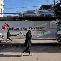 Palestinians walk past the clinic of Doctors Without Borders or Medecins Sans Frontieres (MSF), in the al-Rimal neighborhood of Gaza City on January 11, 2026. (Omar AL-QATTAA / AFP) Palestinians walk past the clinic of Doctors Without Borders or Medecins Sans Frontieres (MSF), in the al-Rimal neighborhood of Gaza City on January 11, 2026. (Omar AL-QATTAA / AFP)