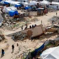 Boys sit atop the fallen minaret of a destroyed mosque in Gaza City on February 7, 2026. (Omar AL-QATTAA / AFP) Boys sit atop the fallen minaret of a destroyed mosque in Gaza City on February 7, 2026. (Omar AL-QATTAA / AFP)