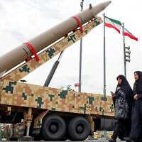 Women walk past a ballistic missile launch vehicle in Tehran on February 11, 2026, during a rally marking the 47th anniversary of the 1979 Islamic revolution (AFP) Women walk past a ballistic missile launch vehicle in Tehran on February 11, 2026, during a rally marking the 47th anniversary of the 1979 Islamic revolution (AFP)