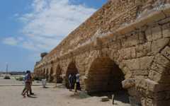 Israelis and tourists enjoy the beach where a 2,000-year-old arch of the Caesarea aqueduct collapse, as seen on August 21, 2023. (Michael Giladi/Flash90) Israelis and tourists enjoy the beach where a 2,000-year-old arch of the Caesarea aqueduct collapse, as seen on August 21, 2023. (Michael Giladi/Flash90)