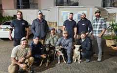 US soldiers pose with three of the ten abandoned dogs from the Gaza border that they will adopt. (Let the Animals Live) US soldiers pose with three of the ten abandoned dogs from the Gaza border that they will adopt. (Let the Animals Live)