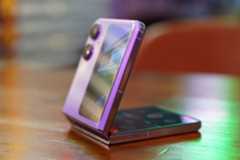 The Oppo Find N2 Flip in purple, on a table, half opened.