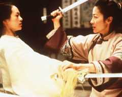 A sword battle between a young woman in a white outfit and an older woman with her weapon upraised.
