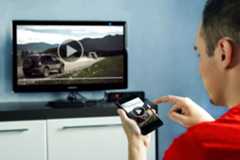 man watching video on smart tv and companion app.