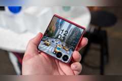 Person holding the Samsung Galaxy Z Flip 7 showing the cover display