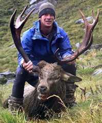 Hunter with a wapiti–red deer