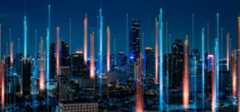 Pictorial representation of an authentication coercion attack. Panoramic view of a city skyline at night, featuring vibrant light beams from skyscrapers and a deep blue sky.