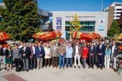 a group of people gathered in front of a new fleet of kayaks at Tennessee RiverLine’s Anchored in Alabama event
