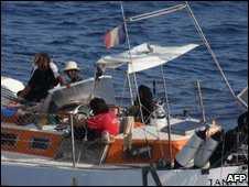 Florent Lemacon (L) and pirates on board the Tanit on 10 April