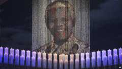 Candles illuminate a portrait of Nelson Mandela in Qunu. Photo: 15 December 2013