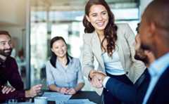 Smiling woman with team talking about corporate governance