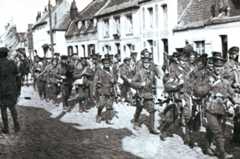 British infantry marching through a French village in August 1914: Battle of Le Cateau on 26th August 1914 in the First World War