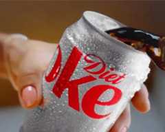 Can of diet coke dripping with condensation being poured out