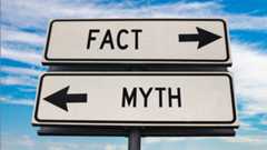 Fact versus myth road sign with two arrows on blue sky background.