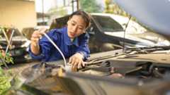Woman checking a car's fluids