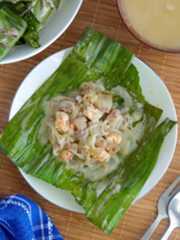 top view of pinais Pinais na Hipon on a banana leaf on a white plate.