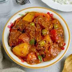 kalderetang baka in a white serving bowl