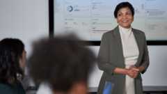 A woman presents information in a meeting.