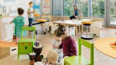 Bright and spacious preschool classroom with five students and a teacher